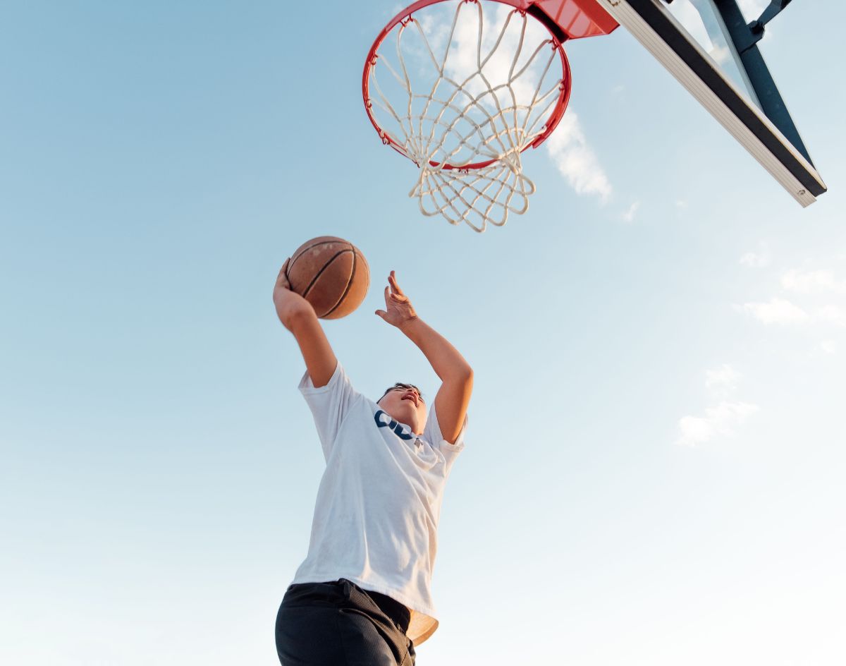 boy using basketball hoop
